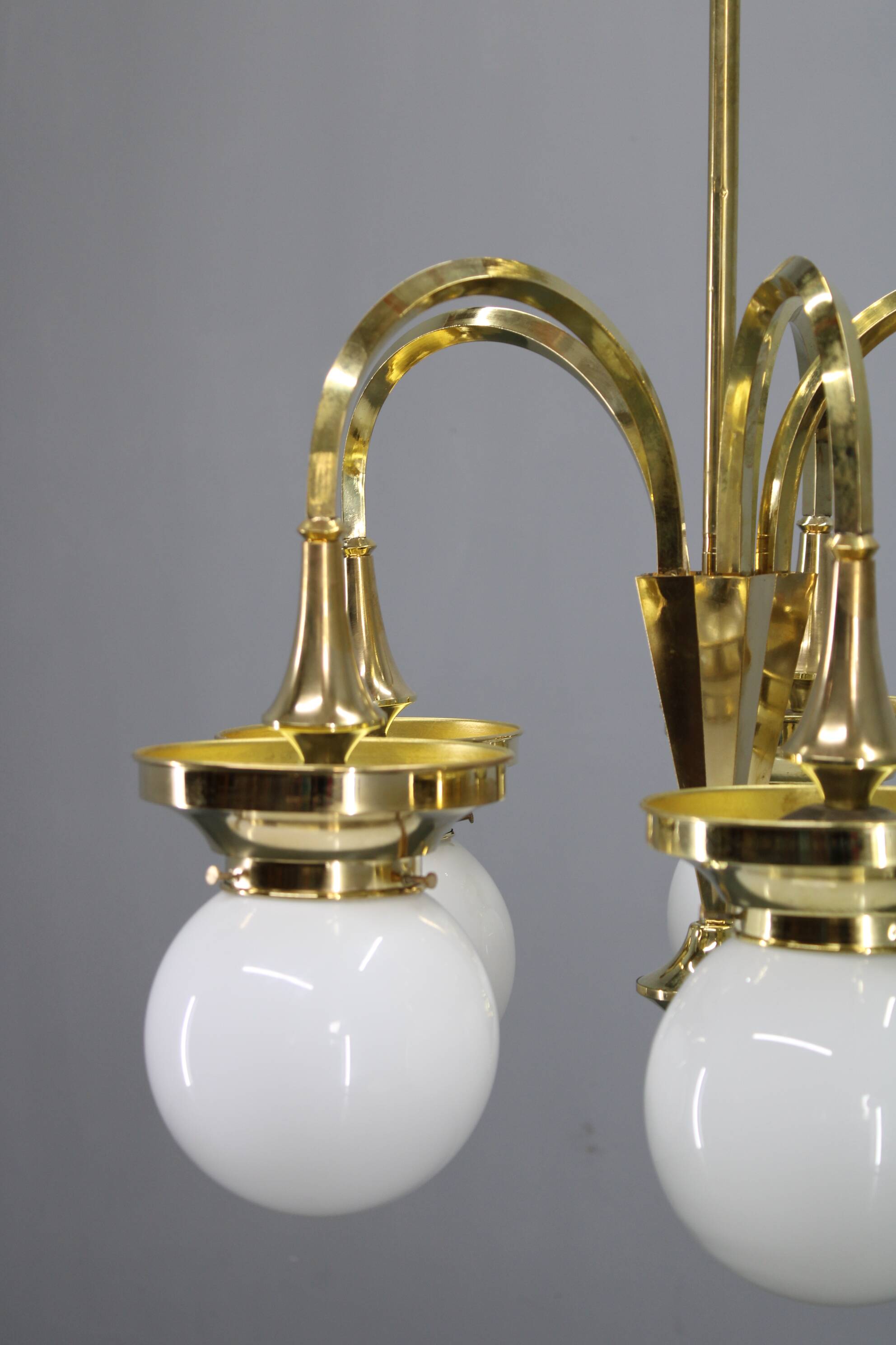 1930s Czechoslovak Art Deco brass chandelier with five opaline glass globes