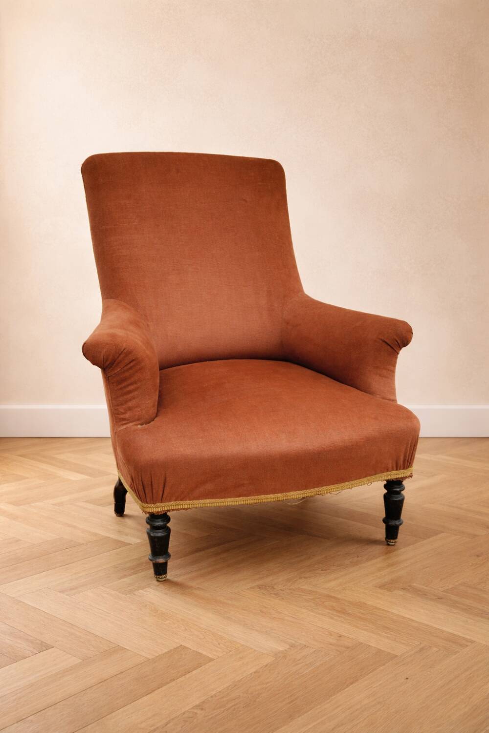 Antique brown velvet tub chair – turned legs and brass rings.