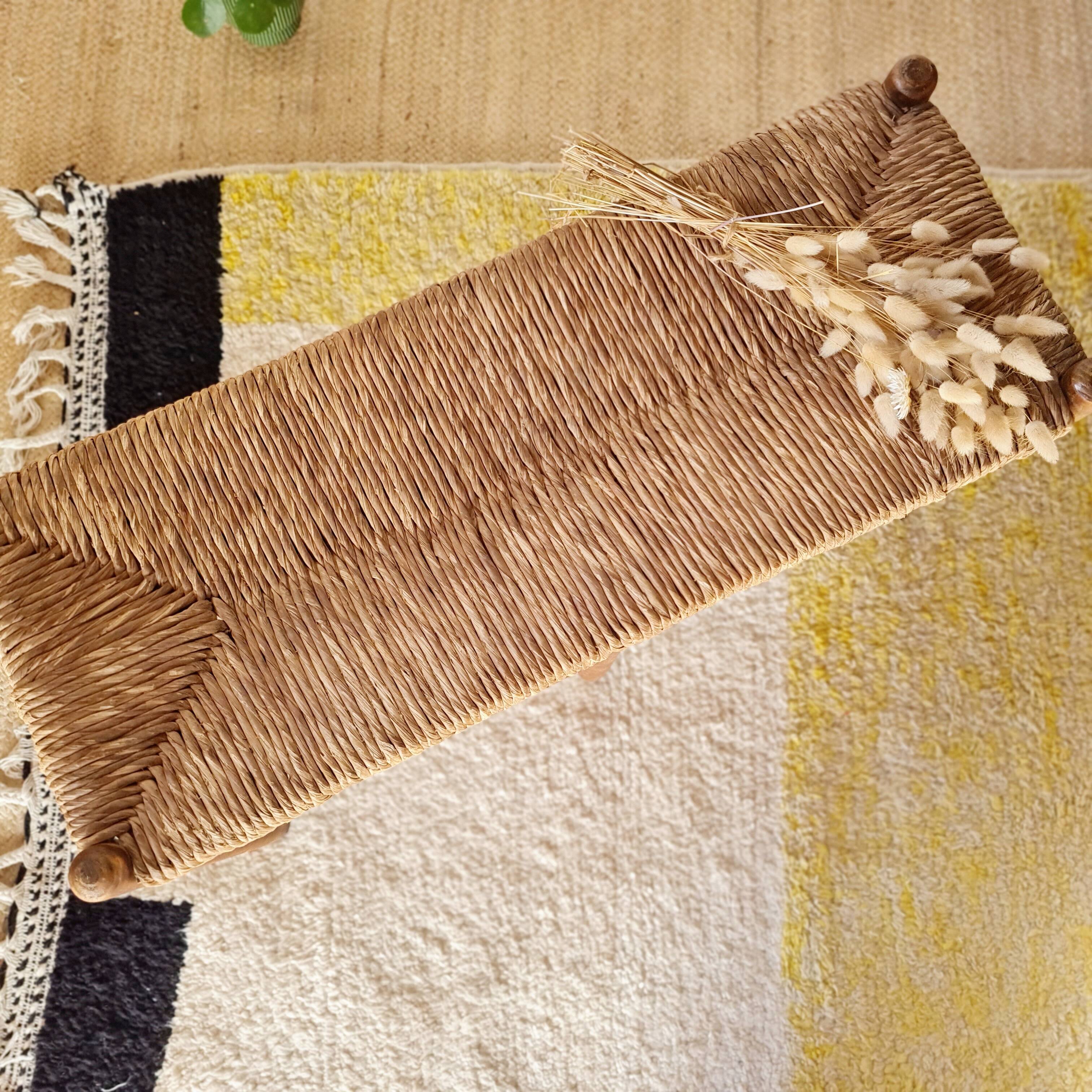 Old wooden and straw bench