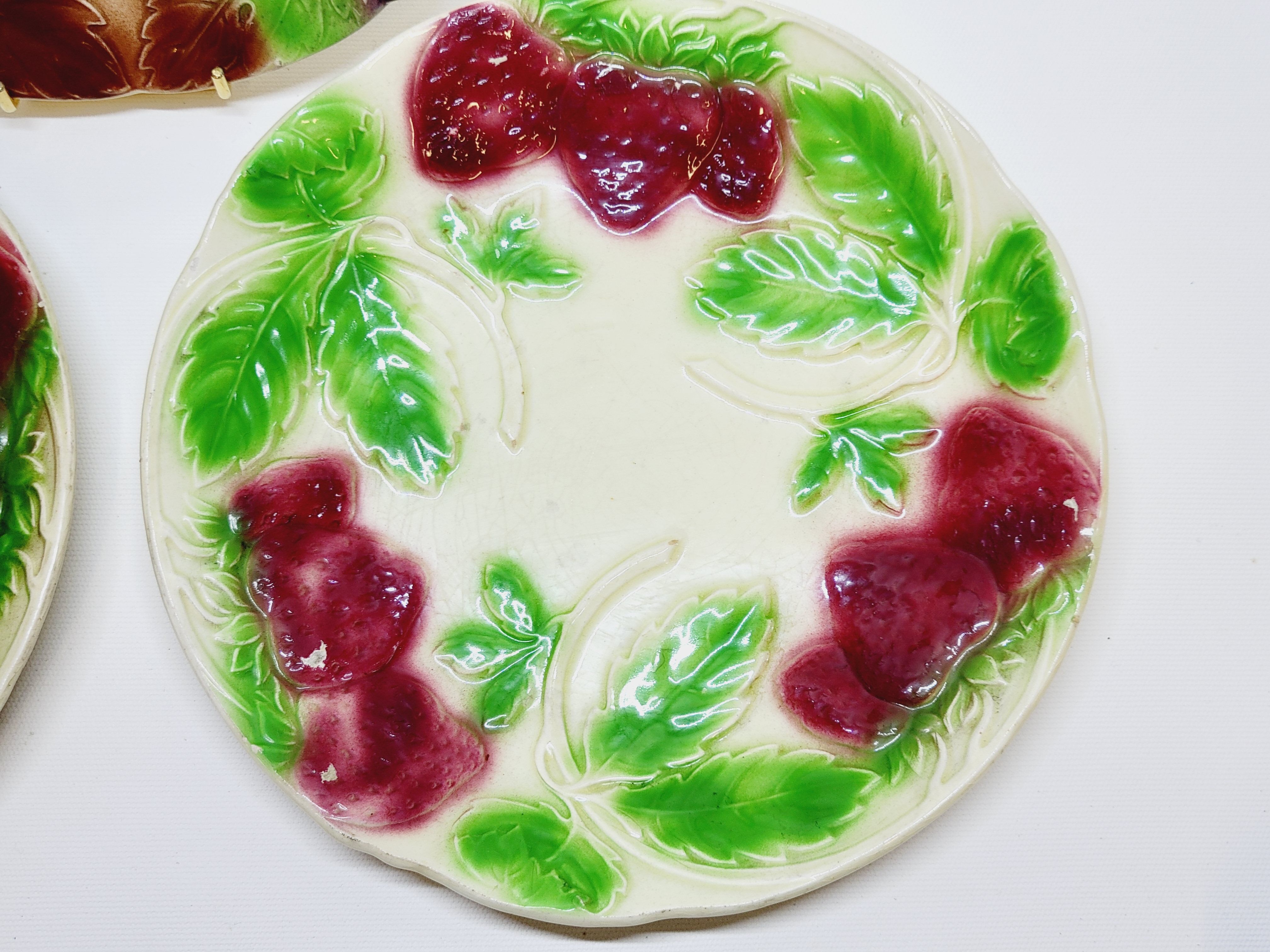 3 old plates in slip decoration strawberries and grapes