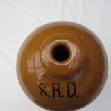 Old wiskhey jug in sand