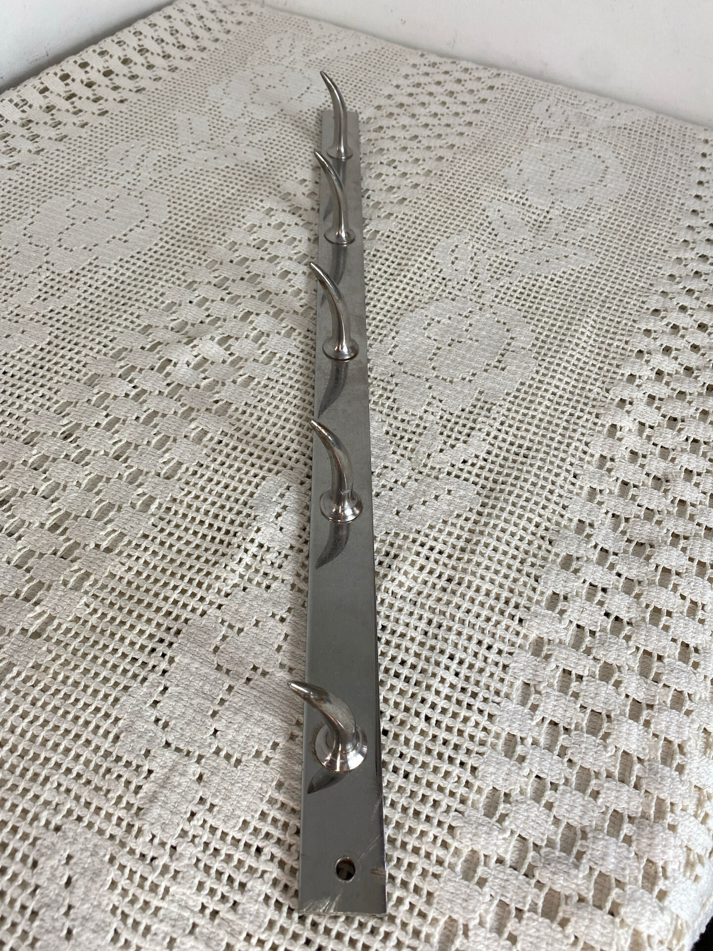 Stainless steel butcher's hook, known as a "wolf tooth bar."