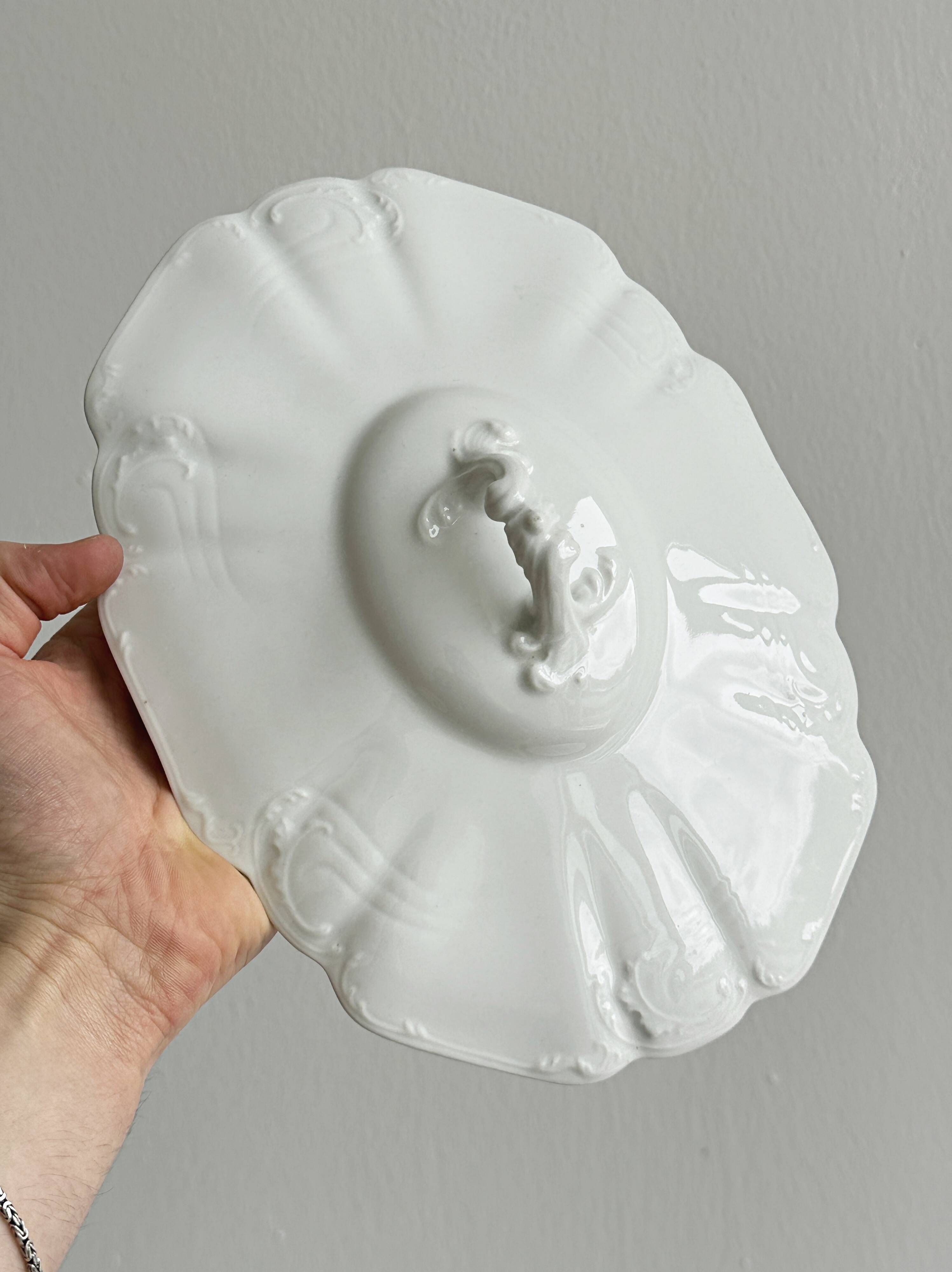 White fine porcelain soup tureen with relief decoration.