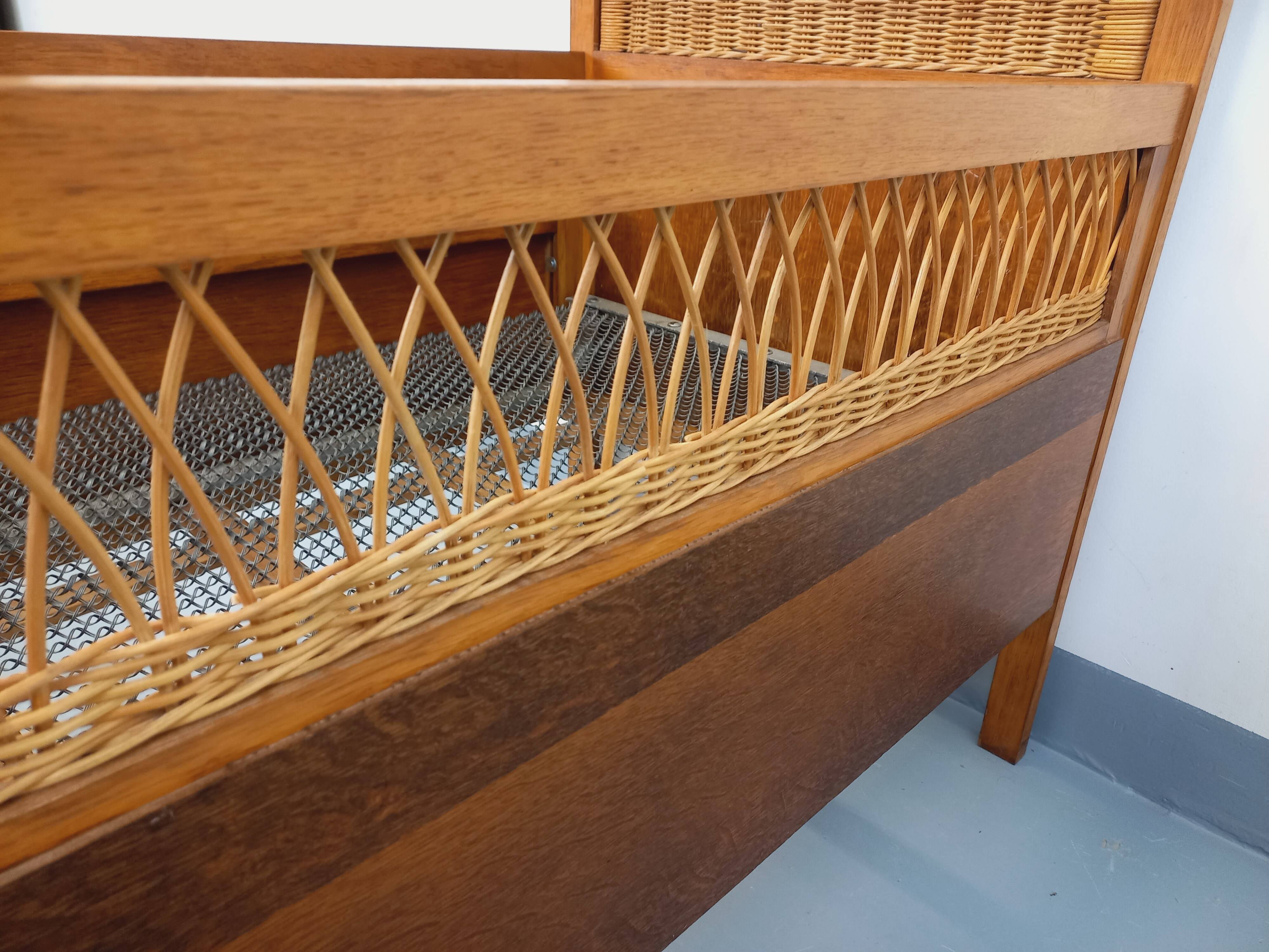 Vintage oak and rattan baby cot from the 1960s.