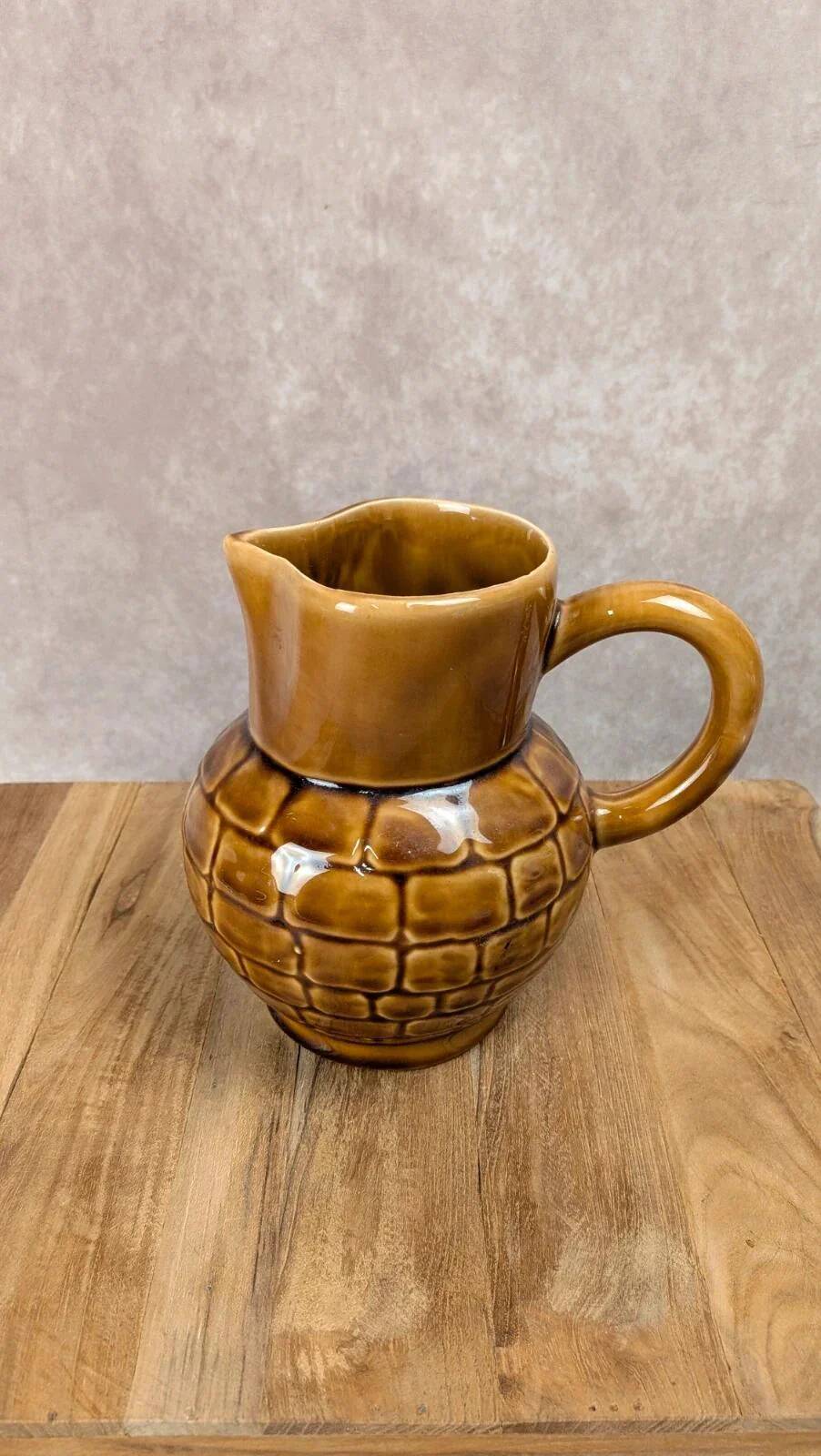 Vintage Sarreguemines pitcher with brown relief decoration.
