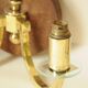 Pair of vintage wall sconces in polished gold brass, wood and glass