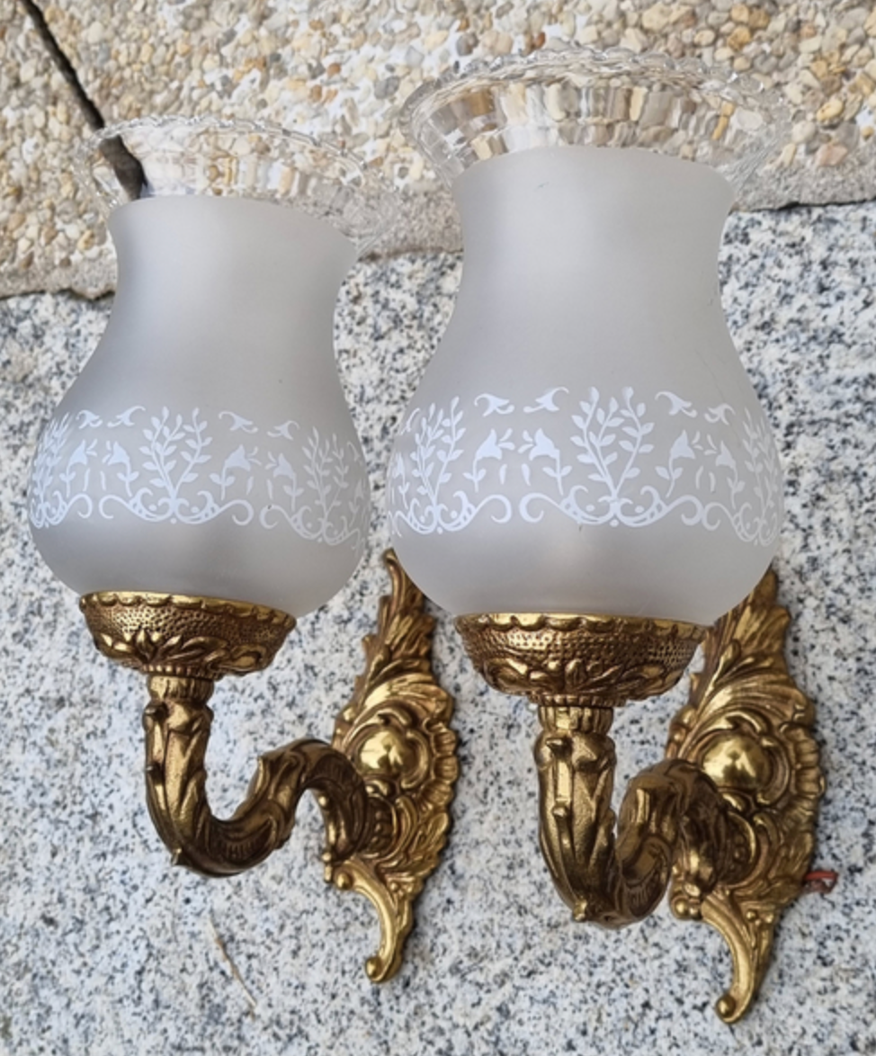 Pair of bronze wall lamps and frosted glass globe, early twentieth century.