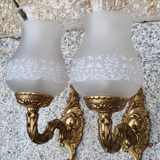 Pair of bronze wall lamps and frosted glass globe, early twentieth century.