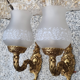 Pair of bronze wall lamps and frosted glass globe, early twentieth century.