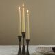 Set of three diabolo-shaped candle holders made of cast steel.