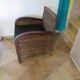 2 colonial-style armchairs in woven rattan and exotic wood