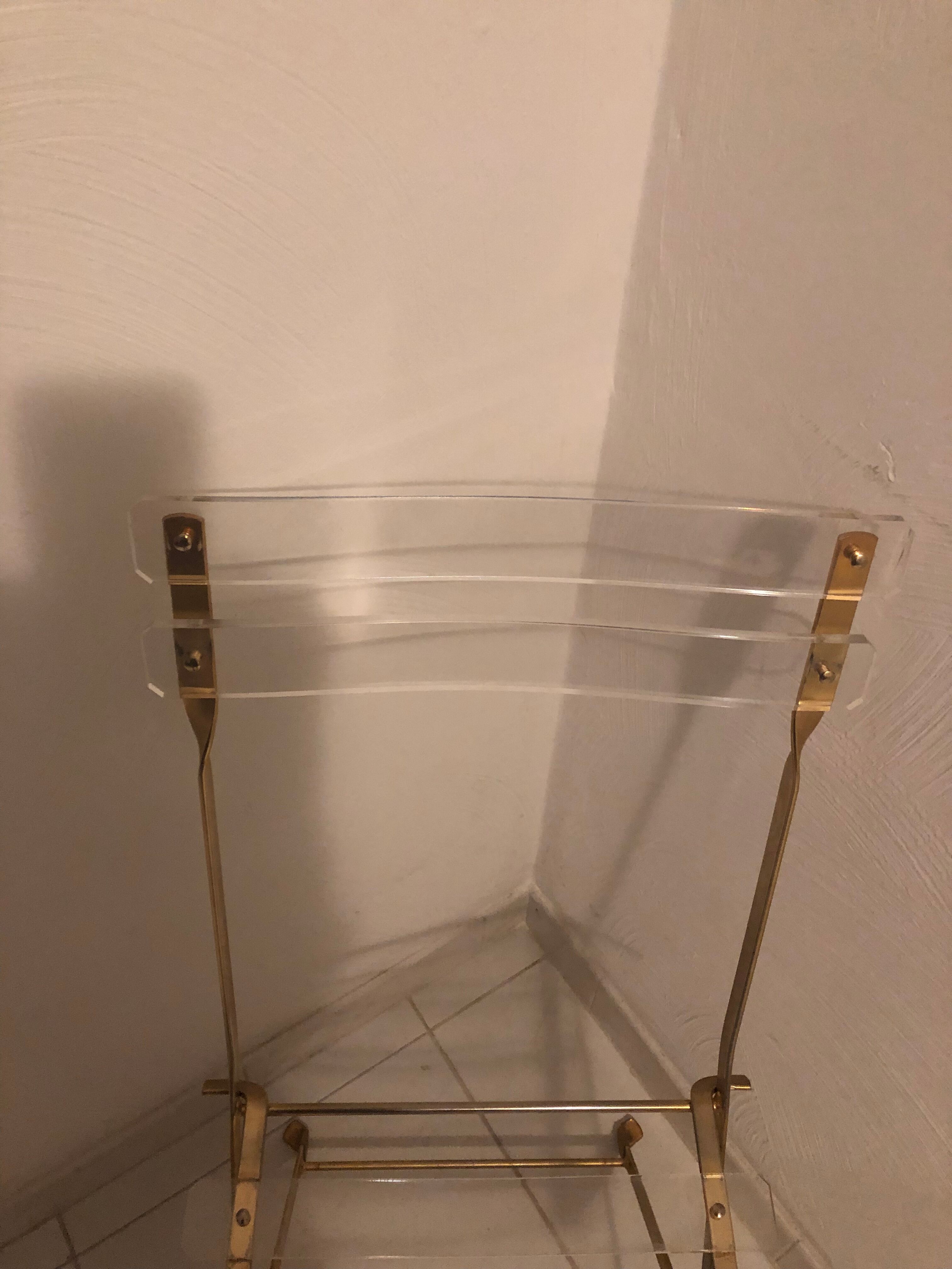 Folding chair in plexiglass and brass