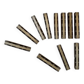 Set of 11 ebony wood knife rests with brass inlay