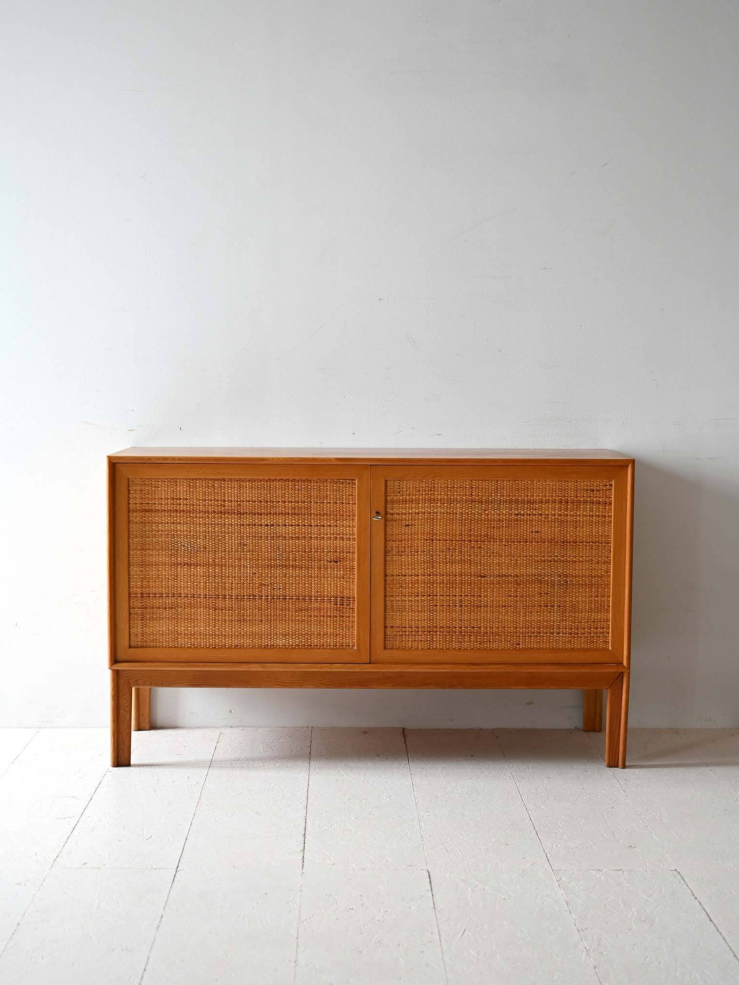 Scandinavian oak cabinet with woven rattan doors