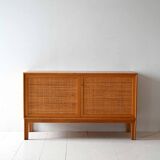 Scandinavian oak cabinet with woven rattan doors