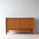 Scandinavian oak cabinet with woven rattan doors