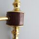 Golden wall lamps with round glass shades and teak veneer
