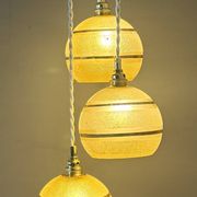 Suspension triple vintage glass globes in frosted yellow and gold.
