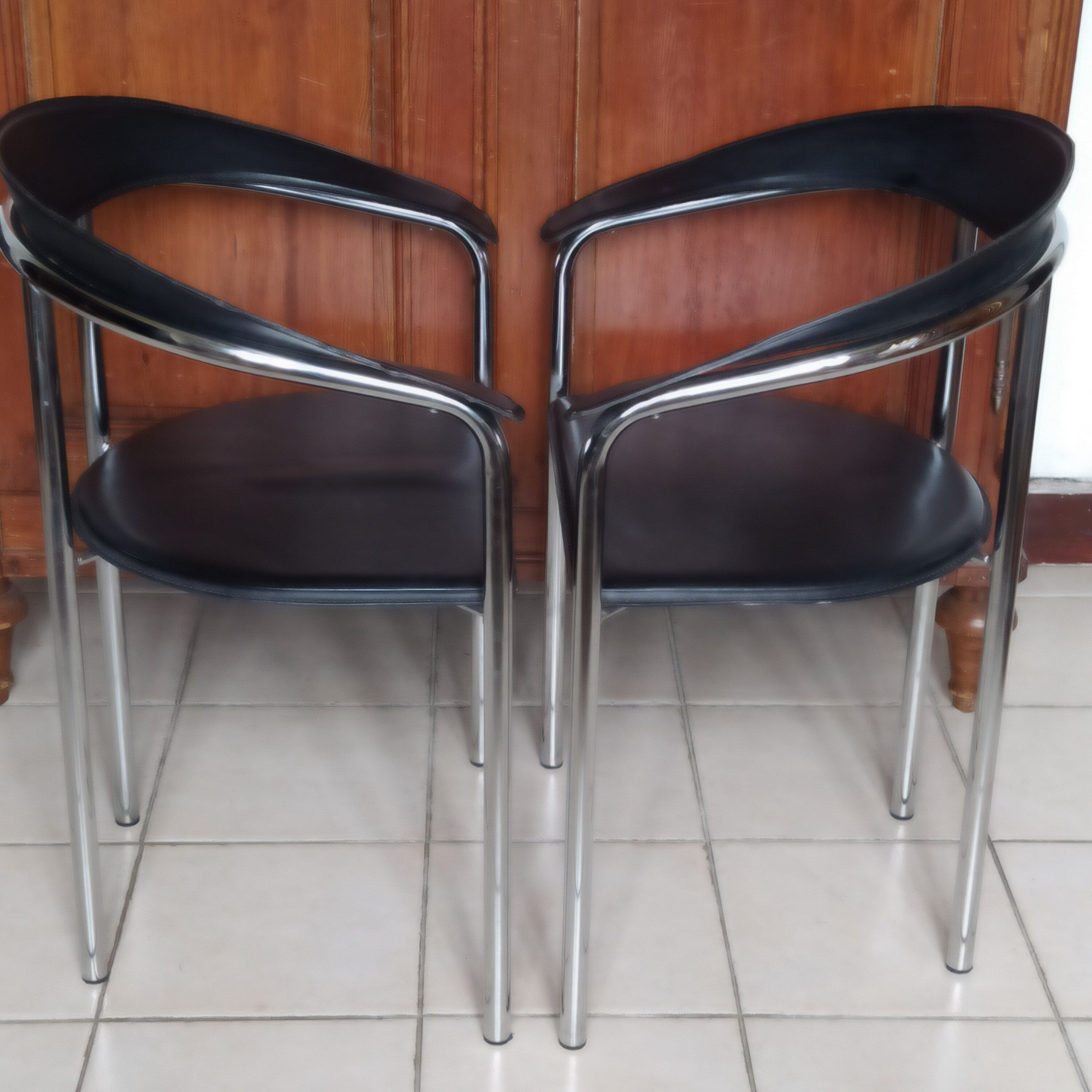 Pair of black and chrome leather Italian armchairs