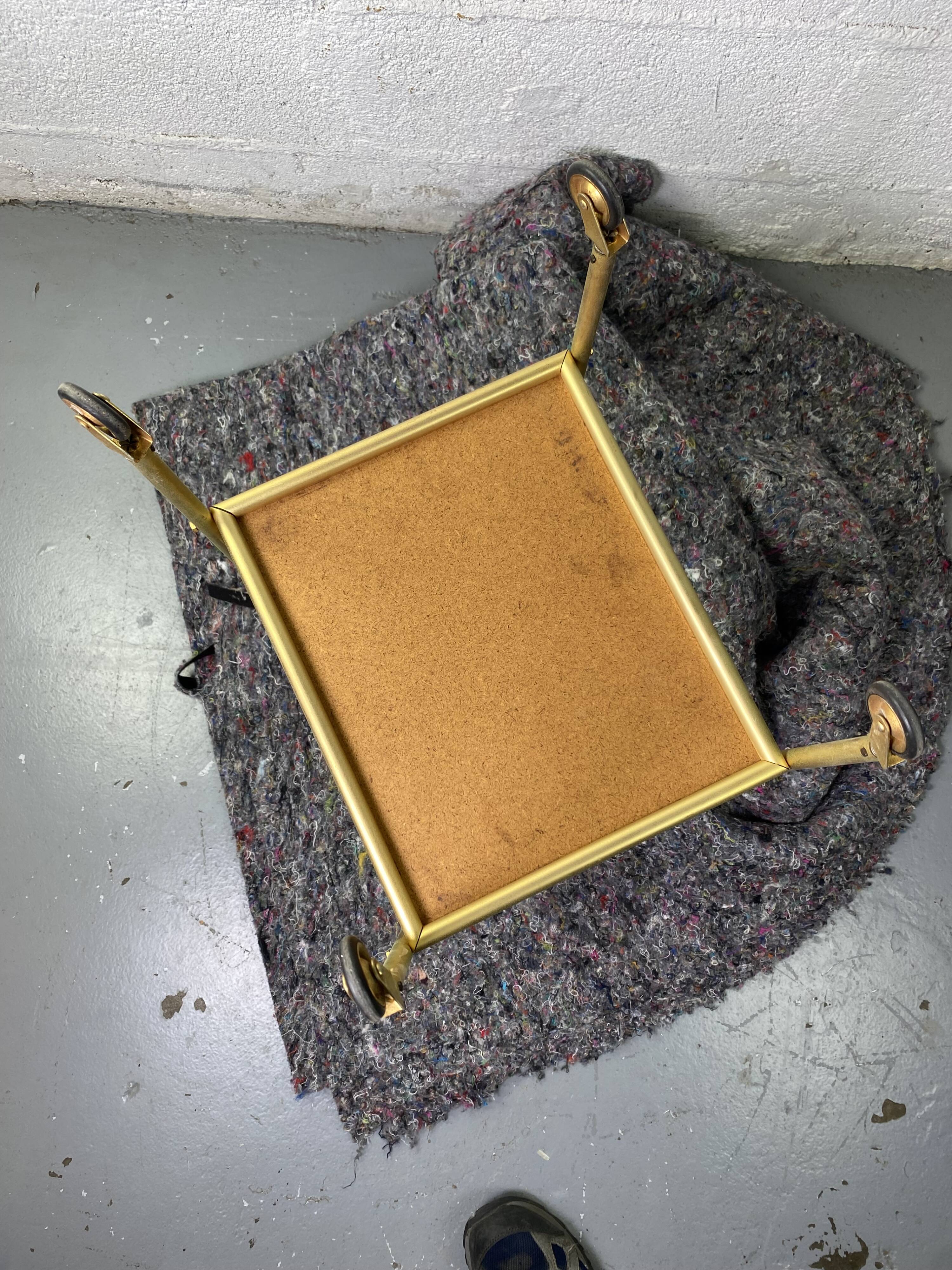 Small rolling trolley in brass and black plastic