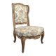 Louis XV style armchair in natural wood with floral fabric.