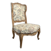 Louis XV style armchair in natural wood with floral fabric.