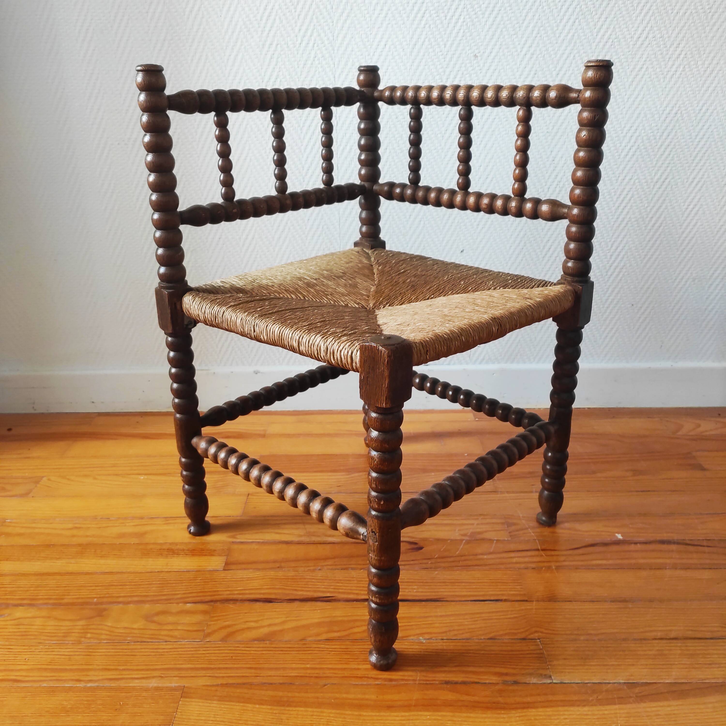 Antique corner chair made of turned wood spindle.