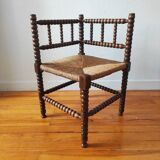 Antique corner chair made of turned wood spindle.