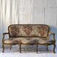Three-seater canapé in carved wood, upholstery and gilded wood. Around 1900, Louis XV style.