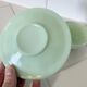 Green opaline coffee cup and saucer in Art Deco style.