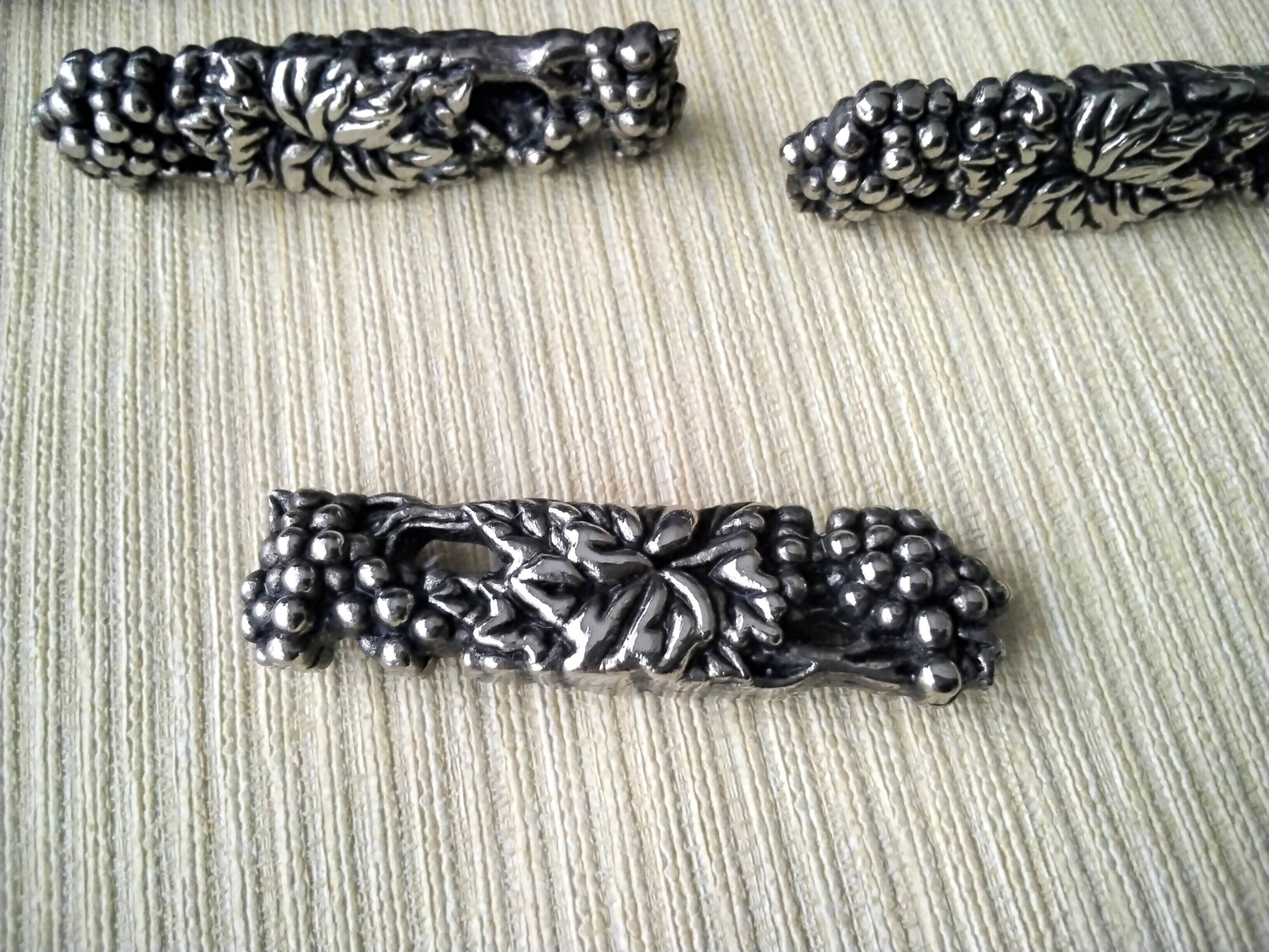 12 Metal knife holders with bunches of grapes and vine leaves