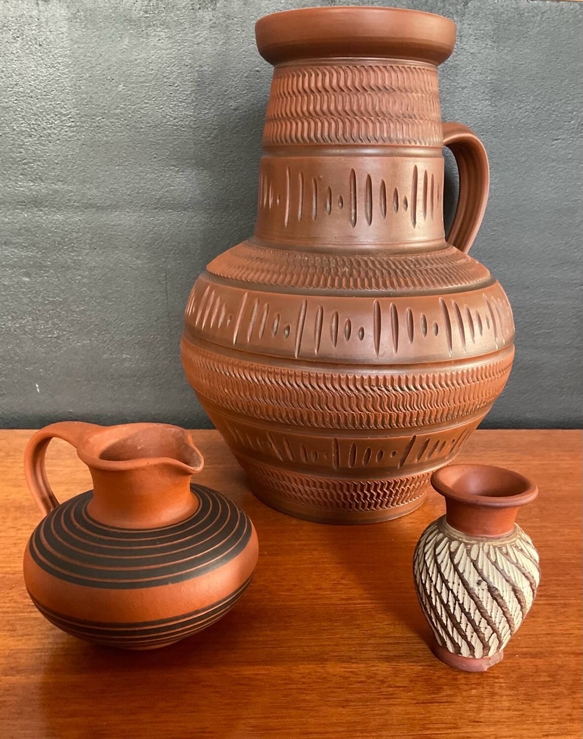 Trio of vintage vases in chiselled terracotta