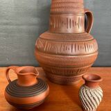 Trio of vintage vases in chiselled terracotta
