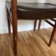 Two leather and Scandinavian teak chairs.