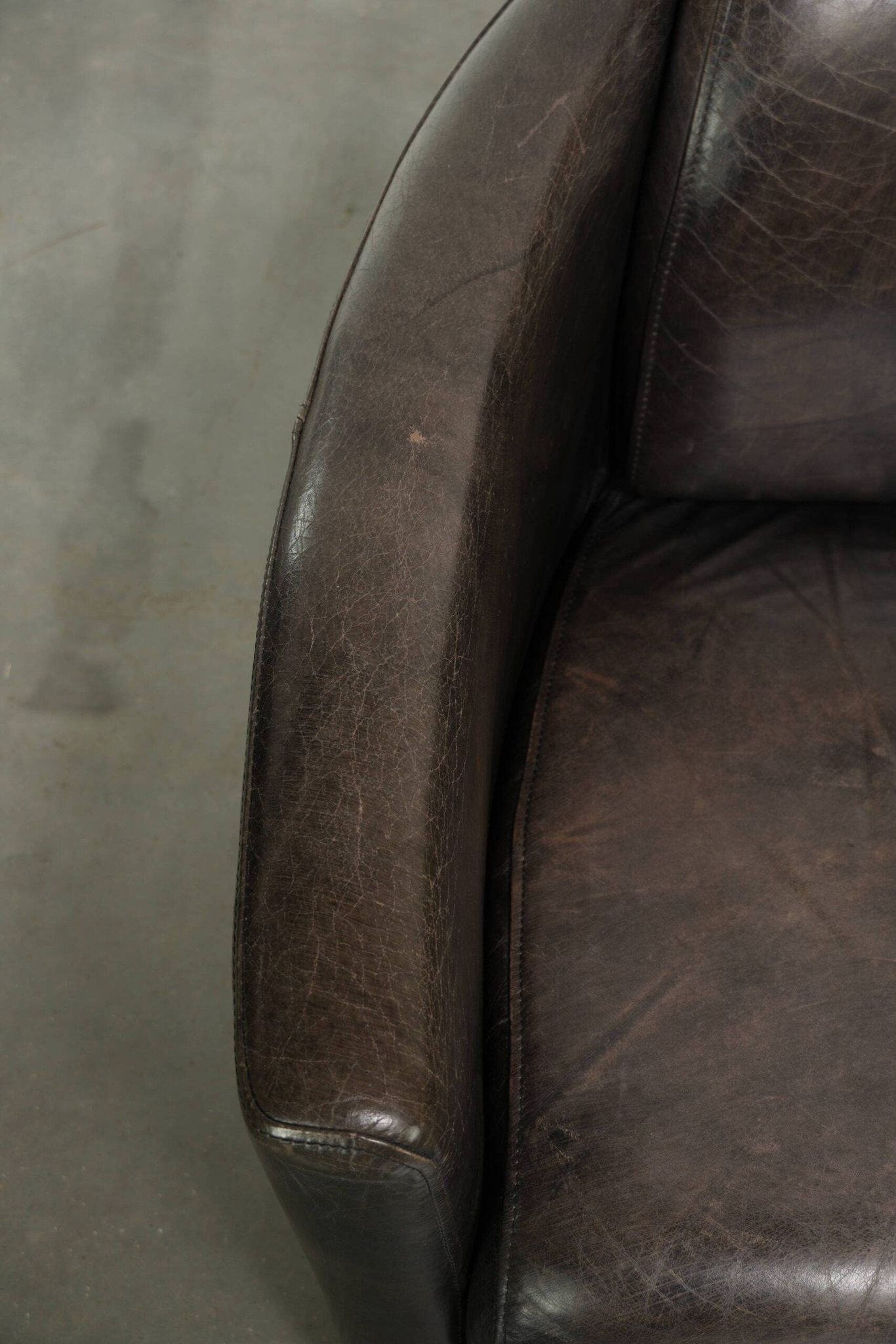 Cow leather Aviator design armchair in a dark colour scheme