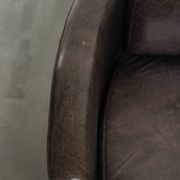 Cow leather Aviator design armchair in a dark colour scheme