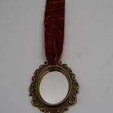 Vintage oval wall-mounted brass mirror