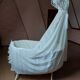 Wrought iron crib painted white from around 1920 with bedding.