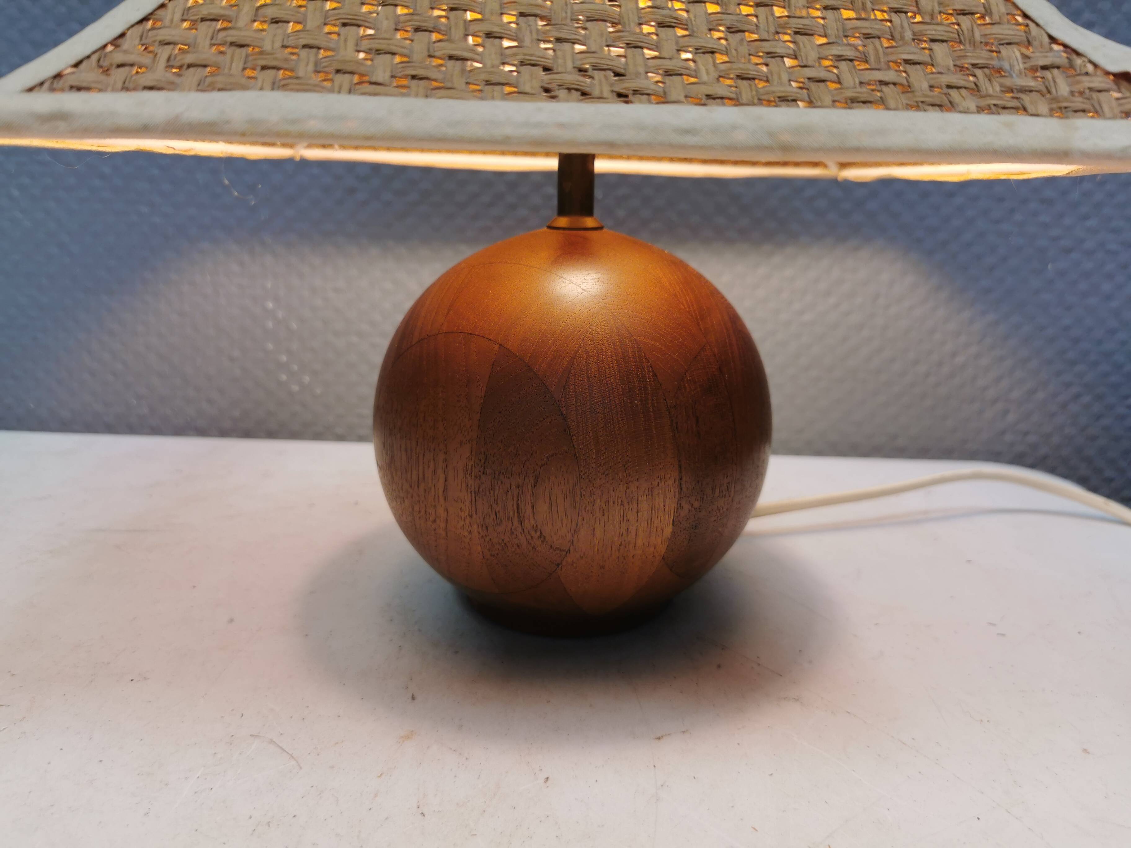 Very rare table lamp in turned teak wood with original braided shade. 1970s
