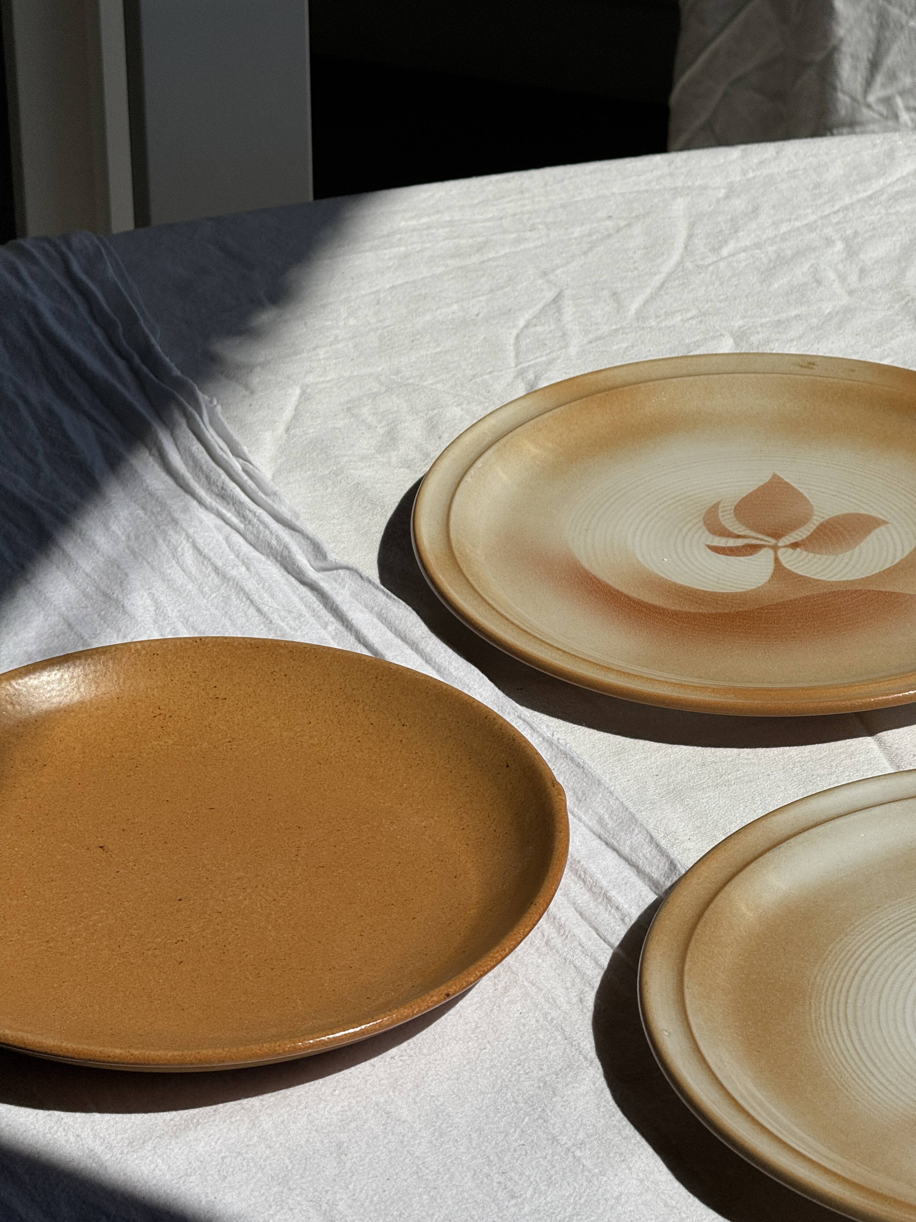 Set of 4 vintage stoneware plates, including 2 with floral motifs