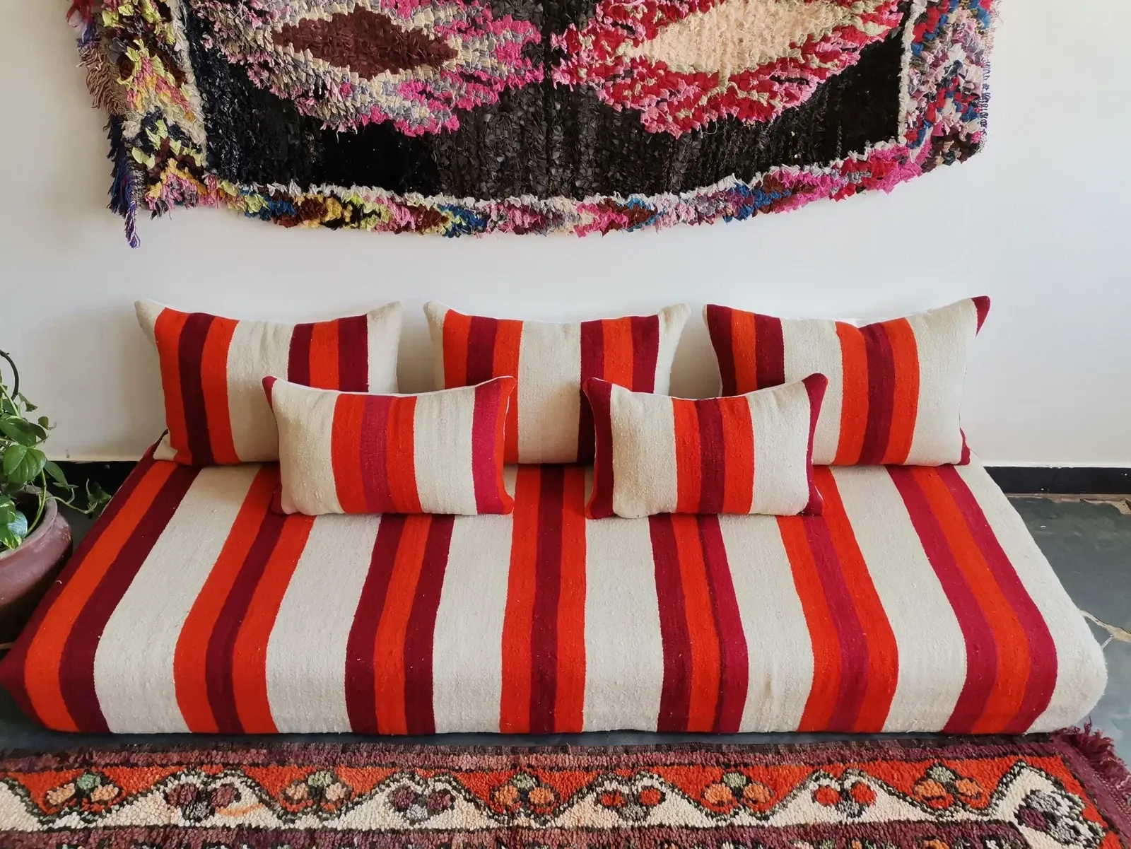 Set of covers for cream and red Moroccan floor sofa.