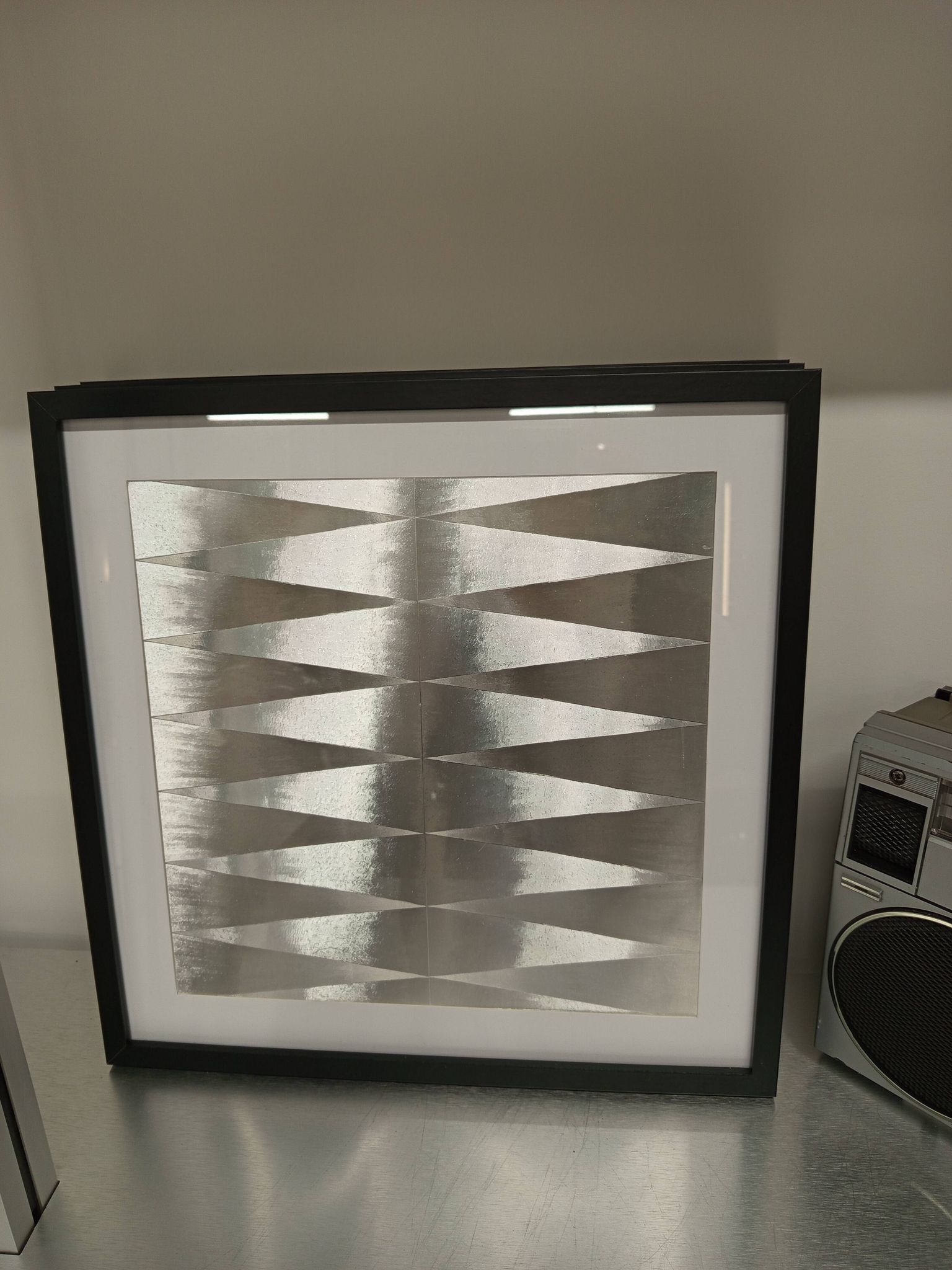 a Kinetic Op Art Aluchromy under glass frame.
