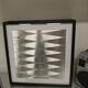 a Kinetic Op Art Aluchromy under glass frame.