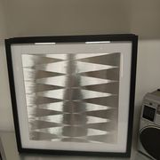 a Kinetic Op Art Aluchromy under glass frame.