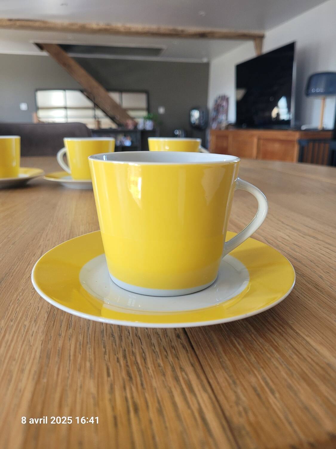 4 yellow and white cups and saucers