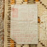 XXL Berber rug with long fringes from the 1960s. Cream-coloured pile with patterns in orange and green tones.