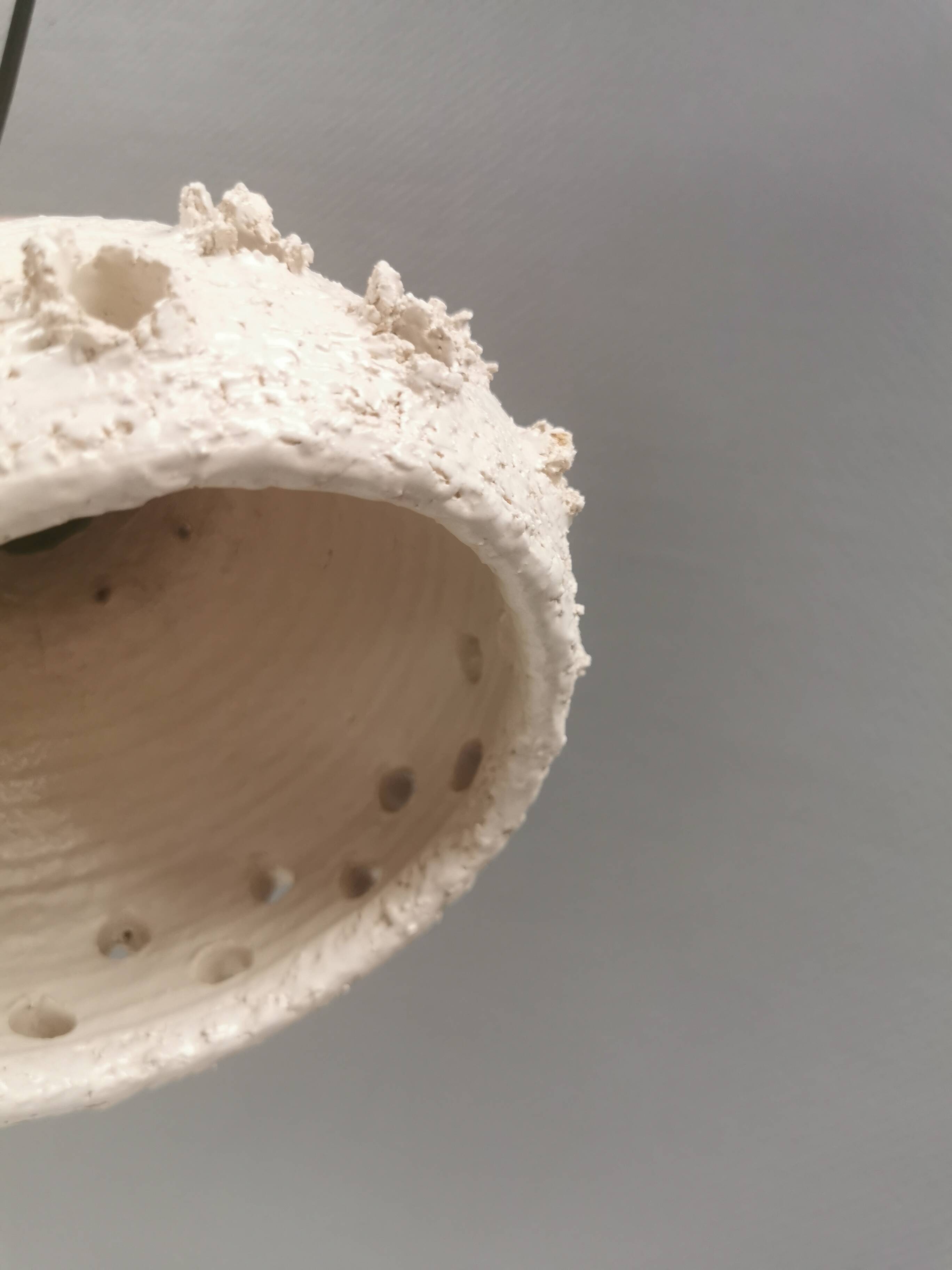 Ceramic hanging lamp in creamy white color that almost looks like a corral