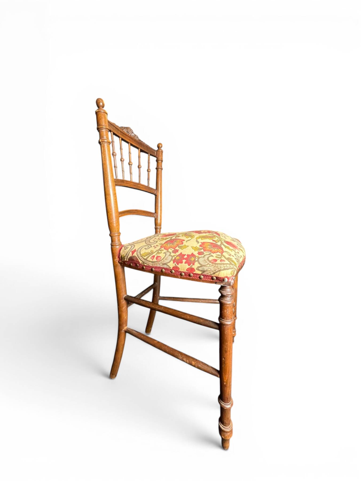 Two floral upholstered music chairs from the early 20th century.