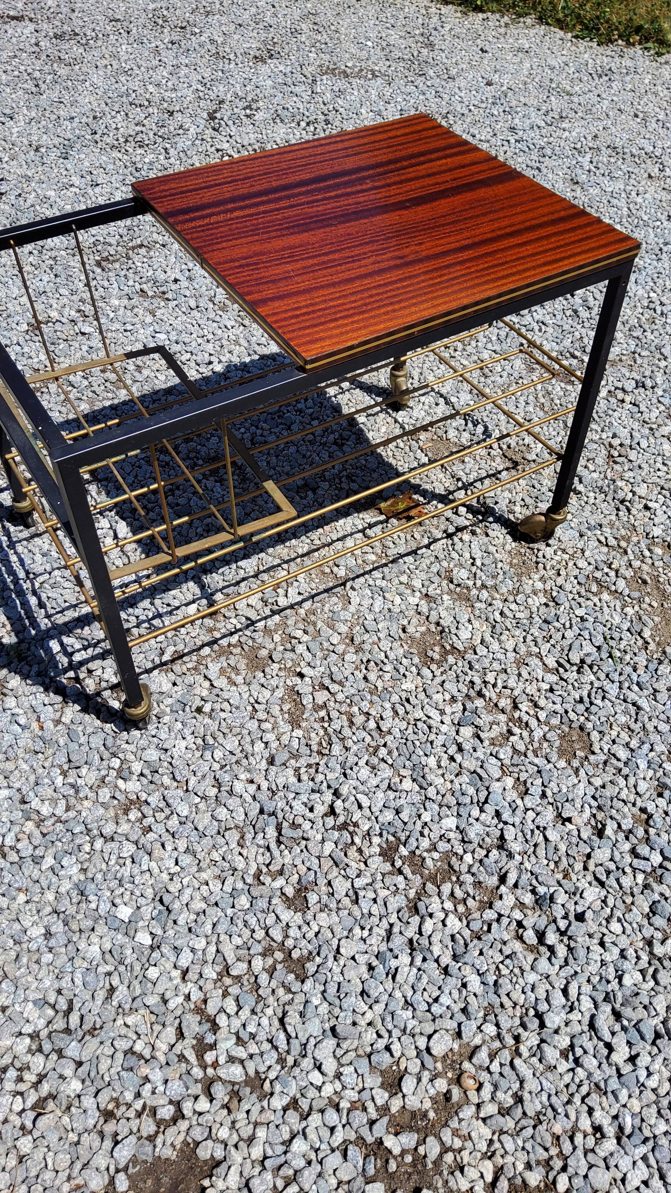 Coffee table from the 60s in black and gold metal tubes mahogany formica top