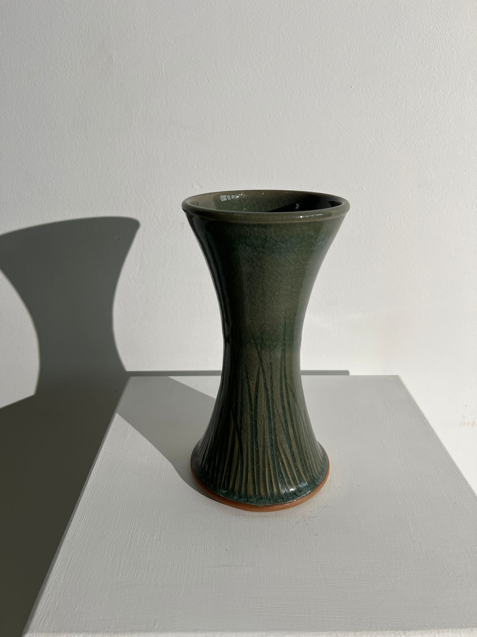 Dark green handcrafted vase with glazed ceramic grass blades